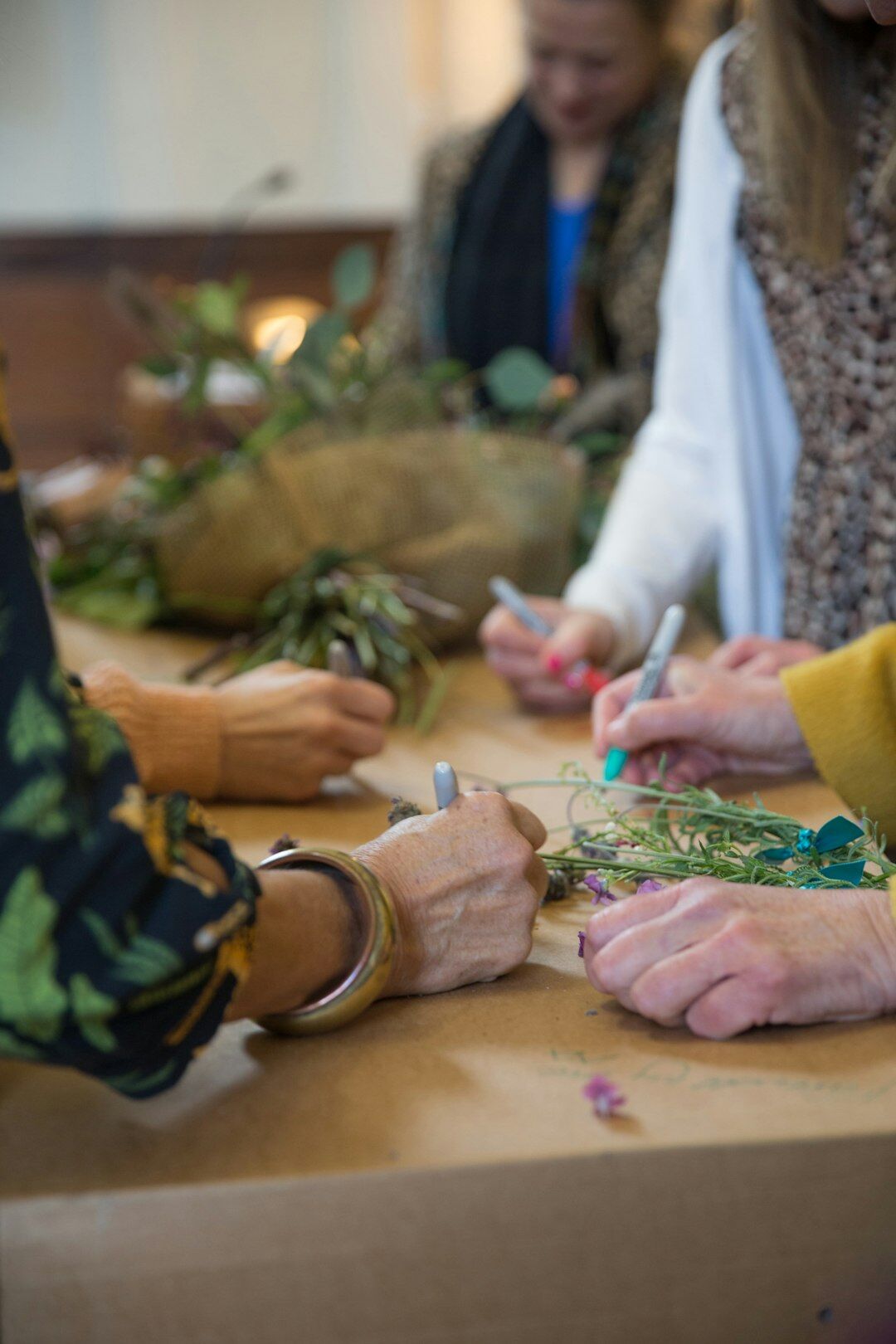 Seniors doing arts and crafts workshop at a table
